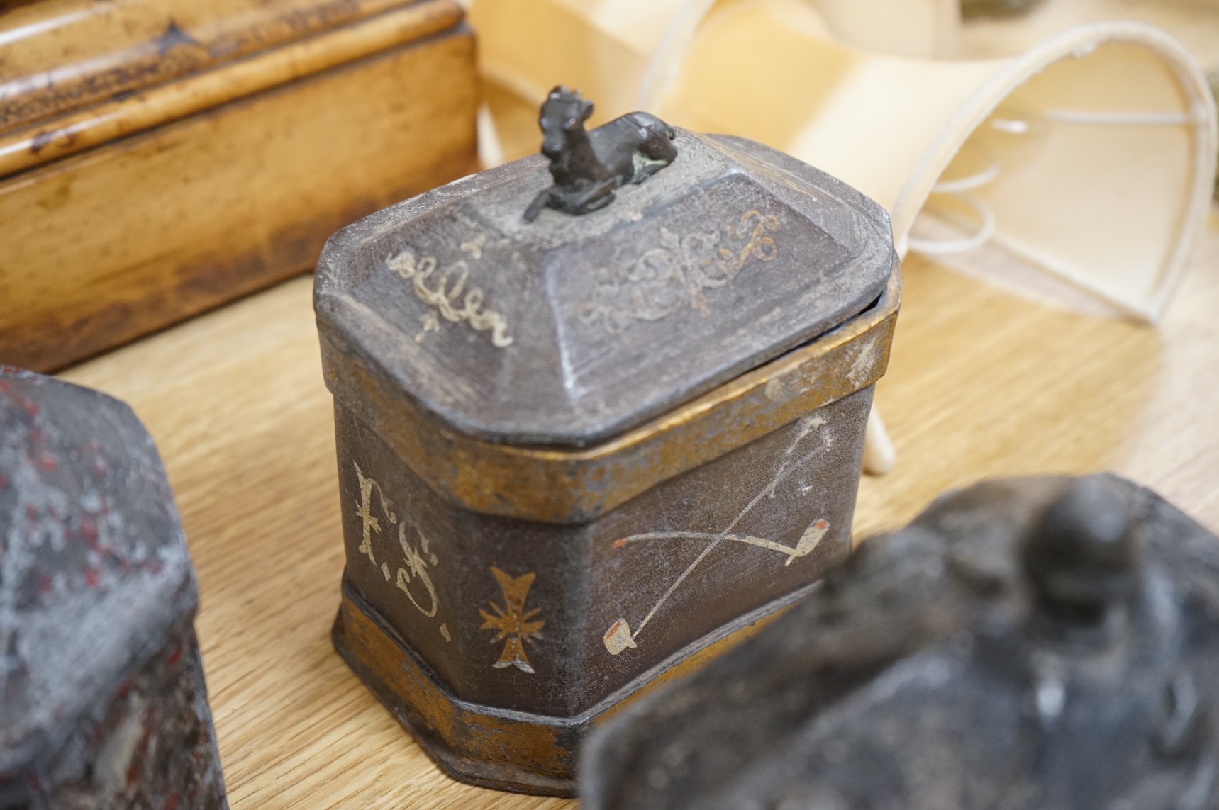 A collection of eleven early 19th century lead tobacco boxes to include an octagonal example with remains of red paint, largest 13cm wide
